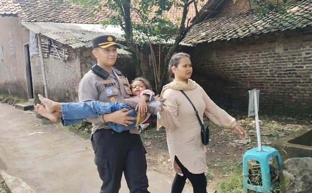 Wakapolres Cirebon Kota, Kompol Rizky Adi Saputro, S.H., S.I.K., M.Si., saat menolong seorang anak perempuan yang terjatuh di kawasan Makam Sunan Gunung Jati, Senin (7/4/2025), dalam pelaksanaan tradisi Grebek Syawal.* (Foto : Ist/CN)